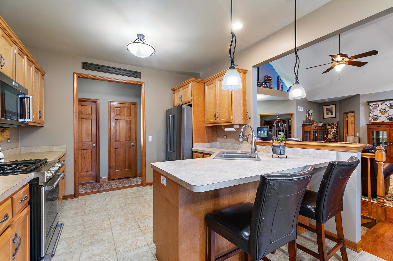 8908 South Hill Road Marengo, IL 60152 - Photo 41 of 53 a kitchen with stainless steel appliances granite countertop a stove a refrigerator a oven a sink with a dining table and chairs