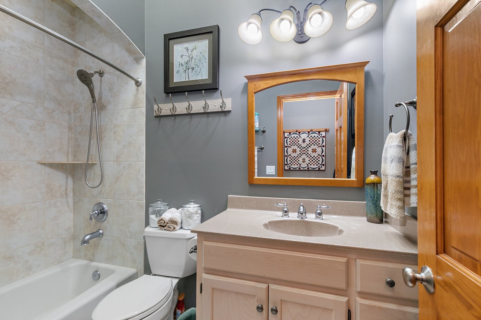 8908 South Hill Road Marengo, IL 60152 - Photo 49 of 53 a bathroom with a sink a mirror a bathtub and a toilet