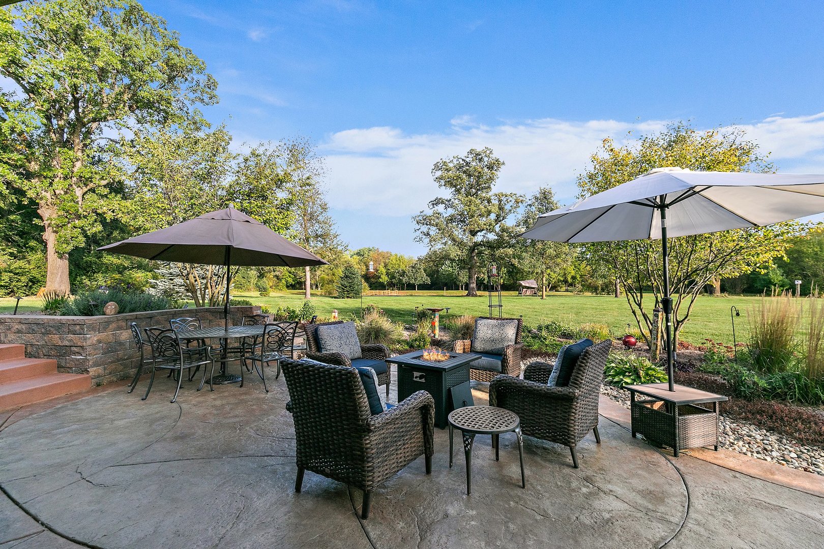 8908 South Hill Road Marengo, IL 60152 - Photo 5 of 53 a view of a tables and chairs under an umbrella in patio with a garden