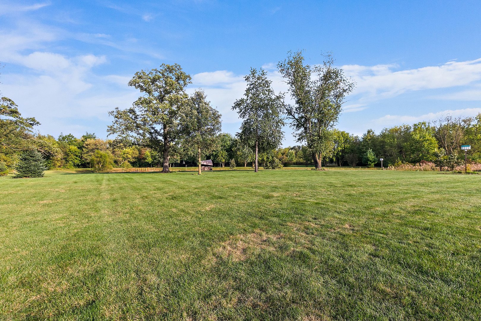 8908 South Hill Road Marengo, IL 60152 - Photo 7 of 53 a view of a green field with trees in the background