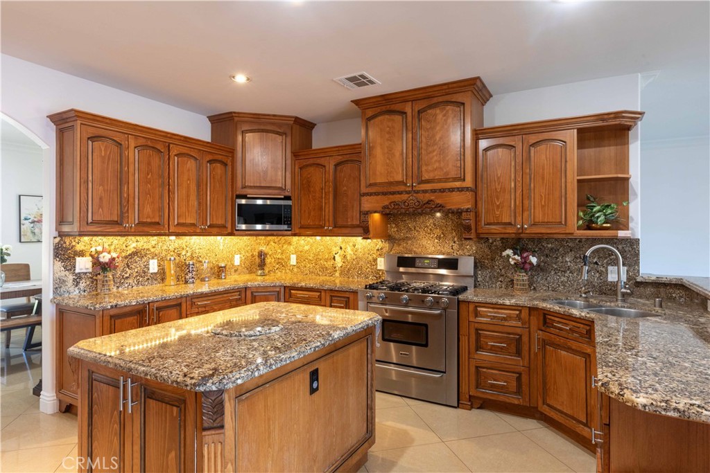19075 Caesar Drive Ramona, CA 92065 - Photo 22 of 75 a kitchen with a stove sink and cabinets
