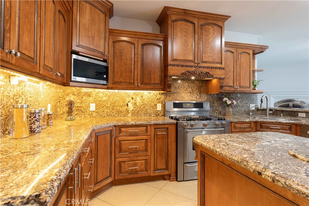 19075 Caesar Drive Ramona, CA 92065 - Photo 25 of 75 a kitchen with stainless steel appliances granite countertop a sink stove and cabinets
