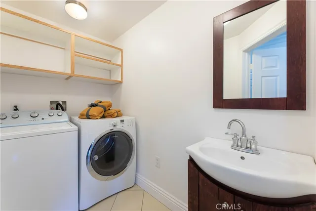 a bathroom with a granite countertop sink a mirror and shower