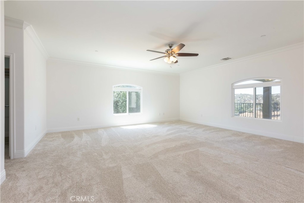 19075 Caesar Drive Ramona, CA 92065 - Photo 34 of 75 an empty room with windows and ceiling fan