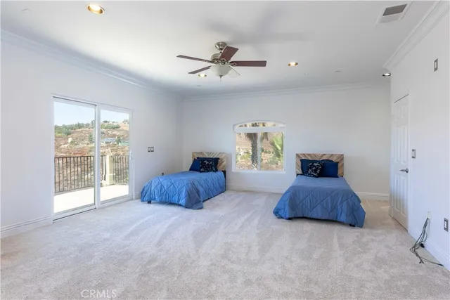 a living room with furniture and a ceiling fan