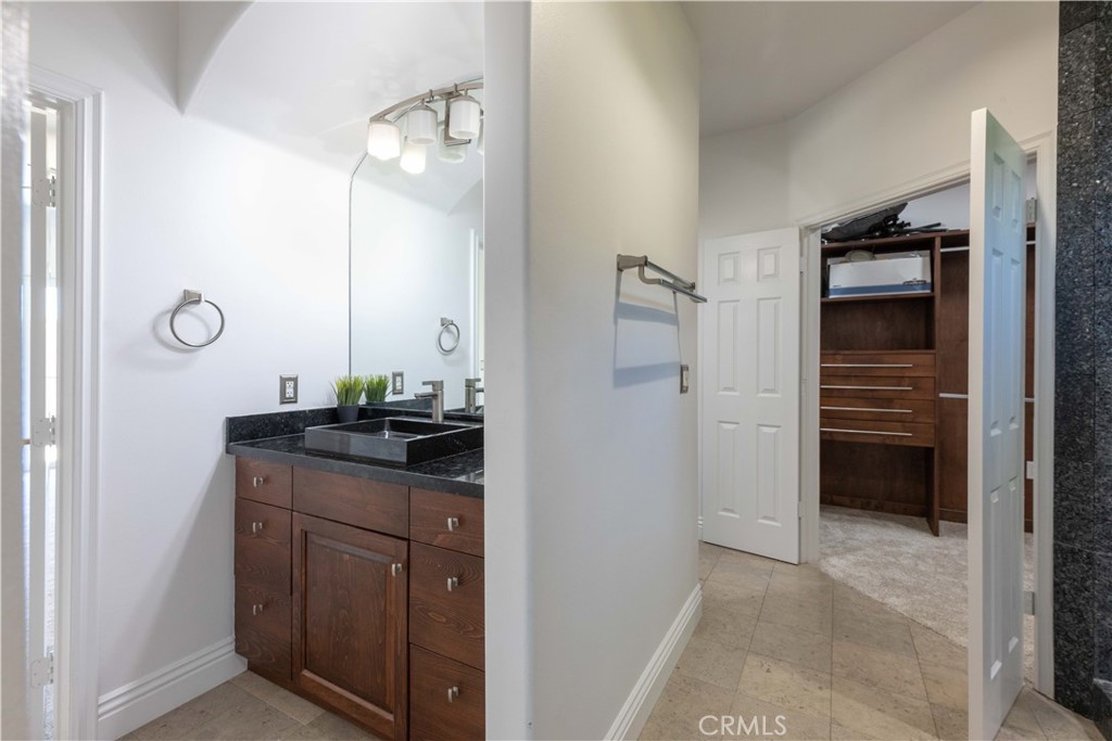 19075 Caesar Drive Ramona, CA 92065 - Photo 45 of 75 a bathroom with a granite countertop sink a mirror and shower