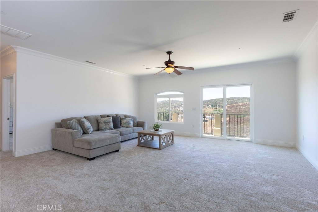 19075 Caesar Drive Ramona, CA 92065 - Photo 54 of 75 a living room with furniture and a chandelier