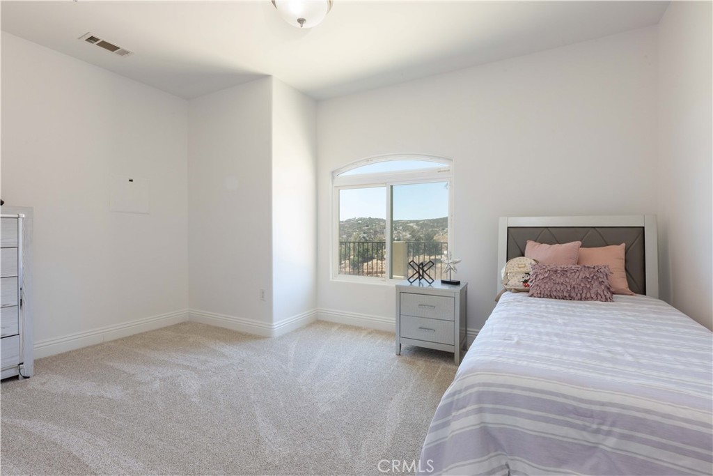 19075 Caesar Drive Ramona, CA 92065 - Photo 60 of 75 a bedroom with a large bed and a large window