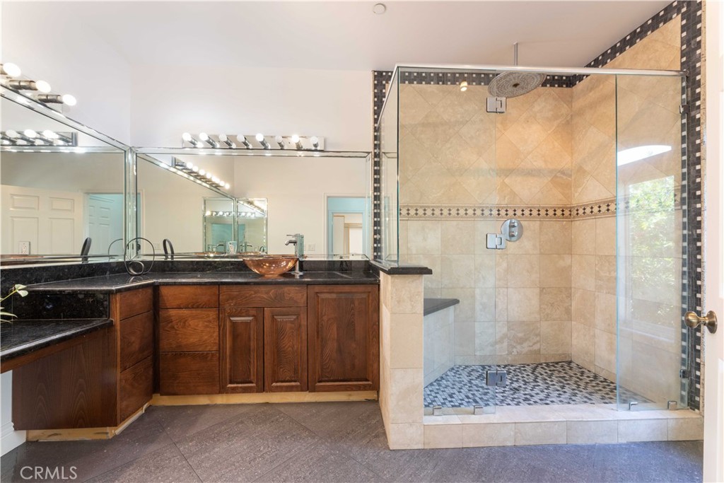 19075 Caesar Drive Ramona, CA 92065 - Photo 62 of 75 a bathroom with a granite countertop sink and a mirror