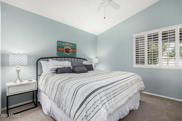a bedroom with double bed and a cabinets