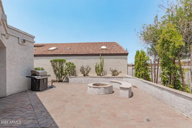 a view of a patio with table and chairs