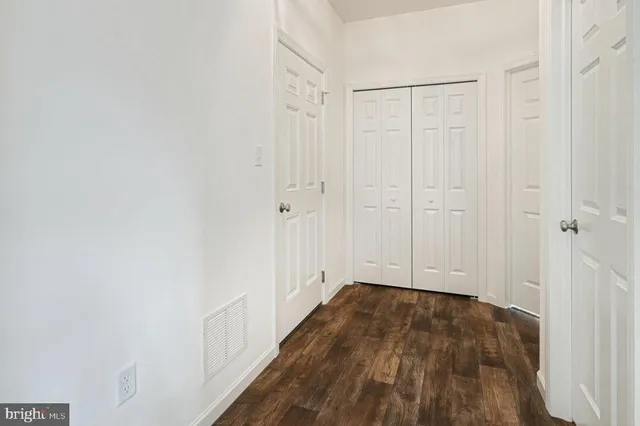 a view of a room with wooden floor