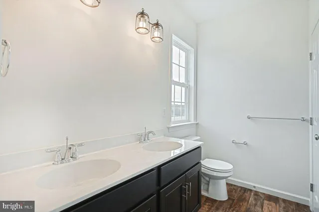 a bathroom with a sink toilet and vanity
