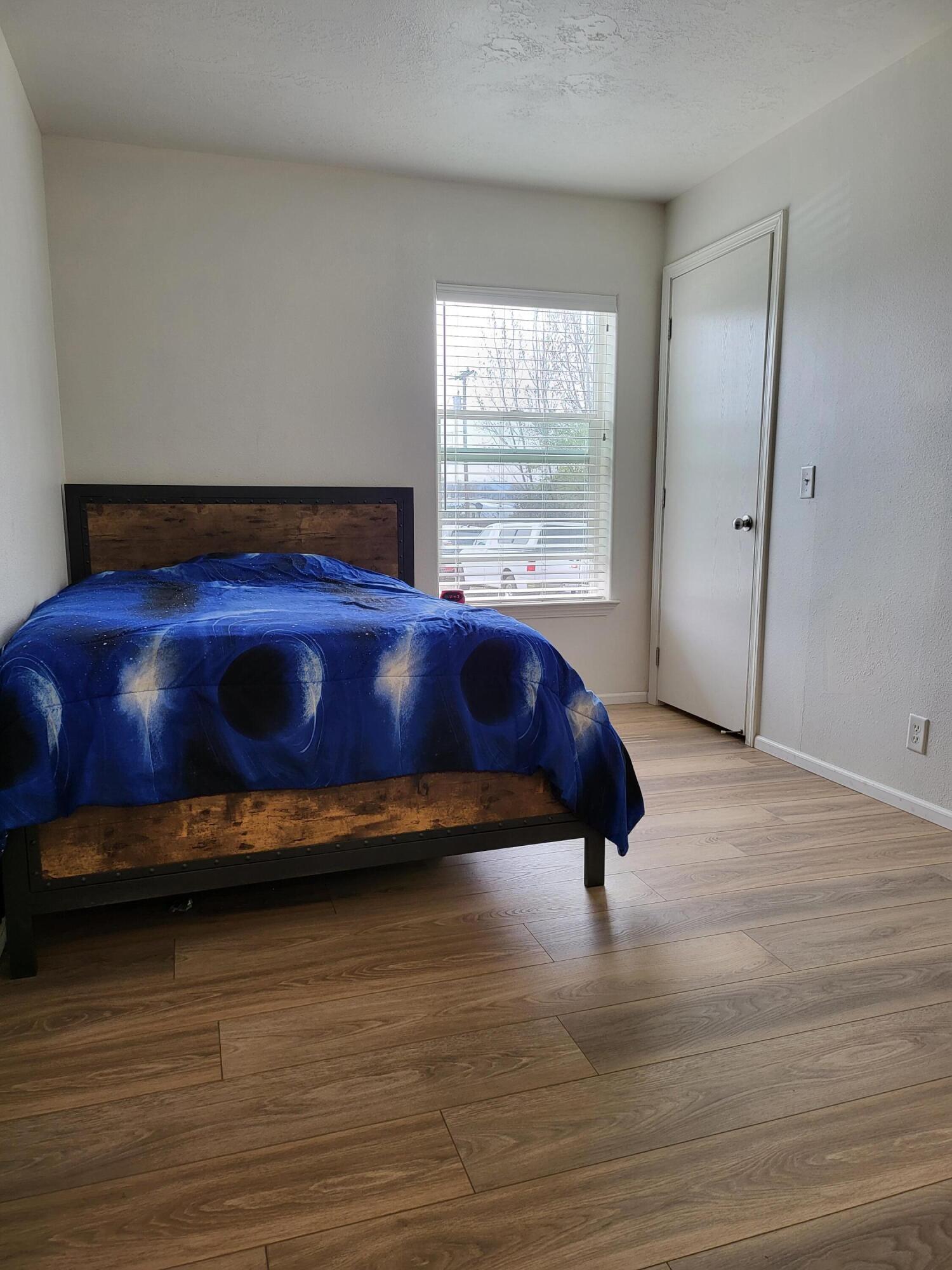 2540 East Gregory Road Central Point, OR 97502 - Photo 16 of 19 a bed sitting in a room next to a window