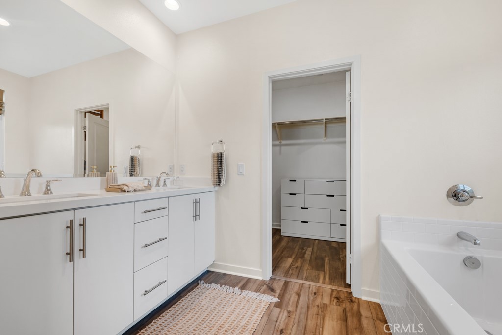 28536 Daybreak Way Saugus, CA 91350 - Photo 14 of 32 a bathroom with a sink a mirror and a bathtub