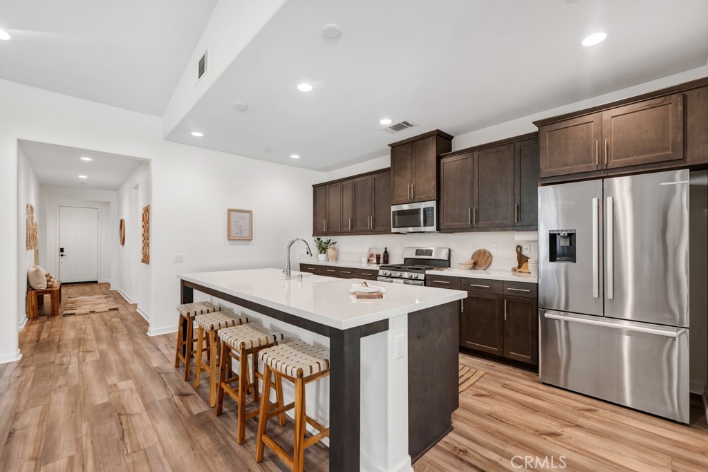 28536 Daybreak Way Saugus, CA 91350 - Photo 20 of 32 a kitchen with stainless steel appliances a stove a sink and a refrigerator