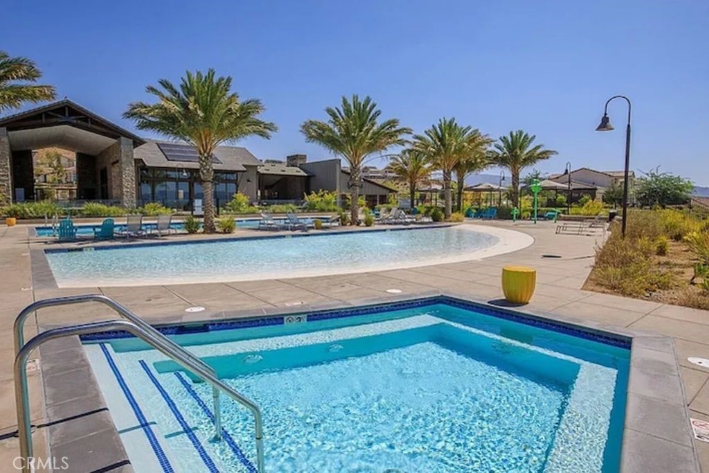 28536 Daybreak Way Saugus, CA 91350 - Photo 28 of 32 a view of swimming pool with a lounge chair and potted plants