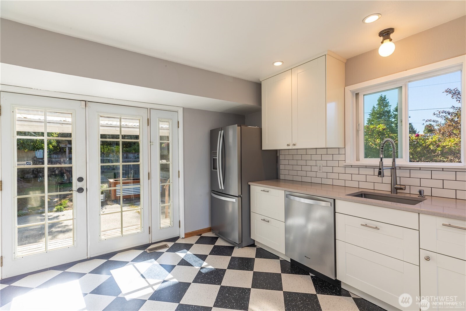 8601 36th Avenue Southwest Seattle, WA 98126 - Photo 11 of 28 a kitchen with a checkered floor and a sink