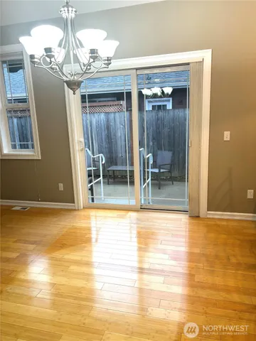a view of empty room with wooden floor and fireplace