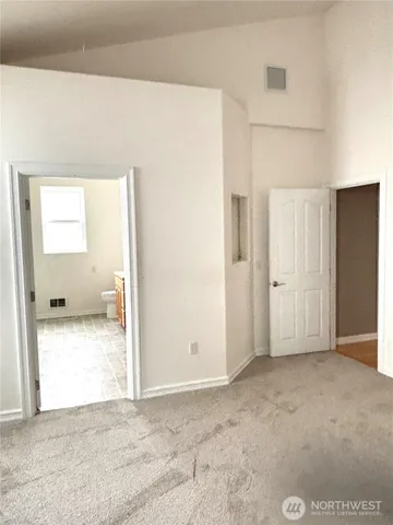 a bathroom with a tub sink and mirror