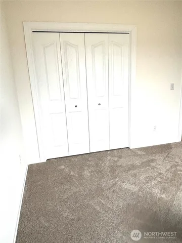 a kitchen with white cabinets and sink