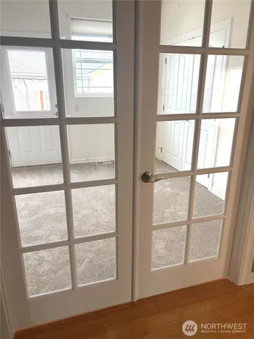 a kitchen with white cabinets and sink