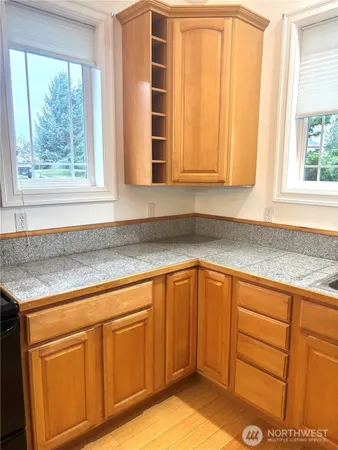a kitchen with granite countertop cabinets and window