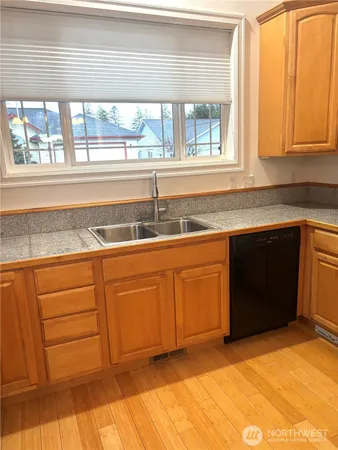 a kitchen with granite countertop a sink and cabinets
