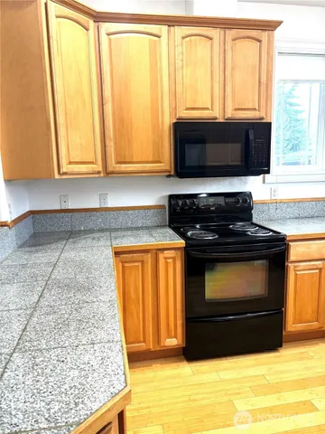 a kitchen with granite countertop a refrigerator and a sink