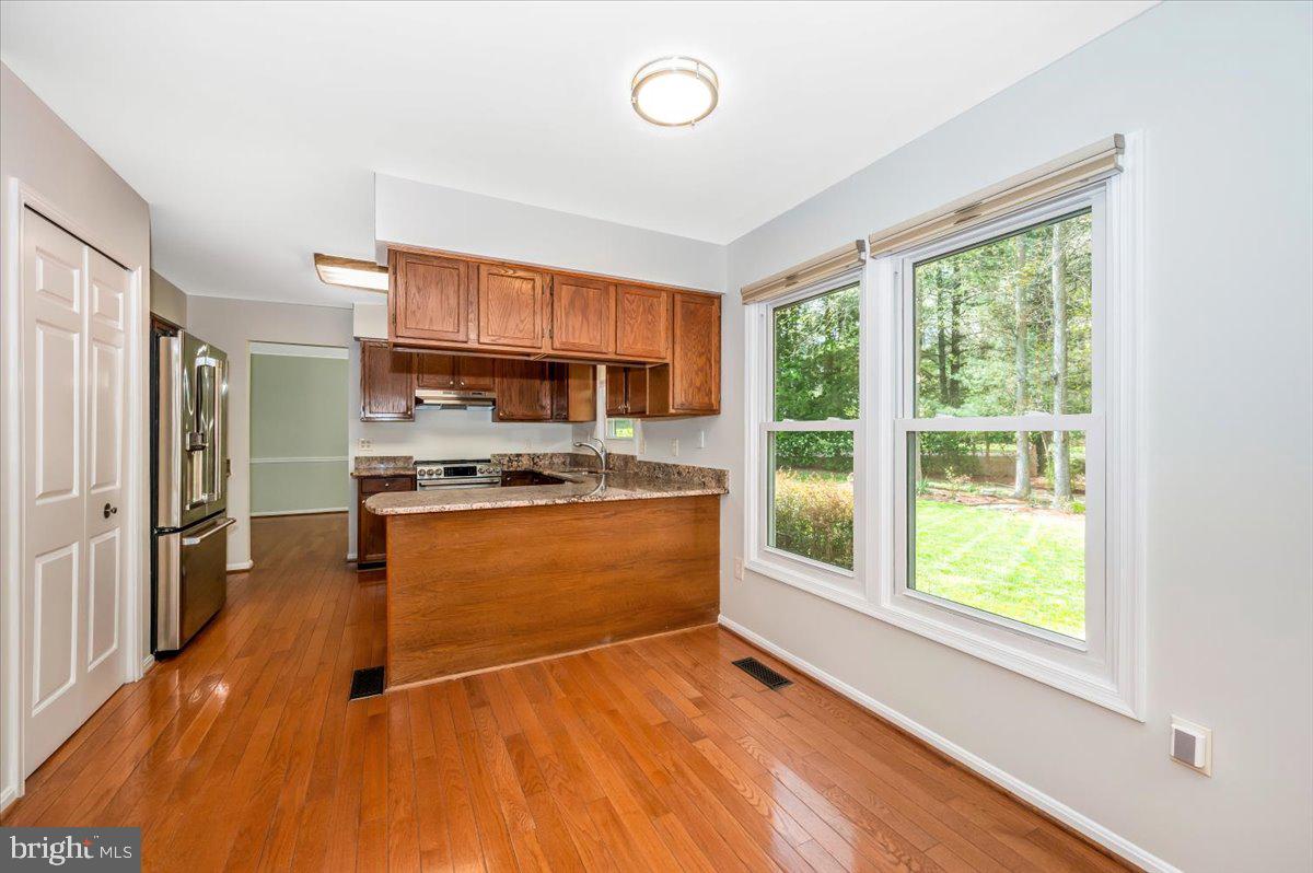 1402 Partridge Lane Bowie, MD 20721 - Photo 12 of 56 a kitchen with stainless steel appliances granite countertop a stove a refrigerator and a view of living room