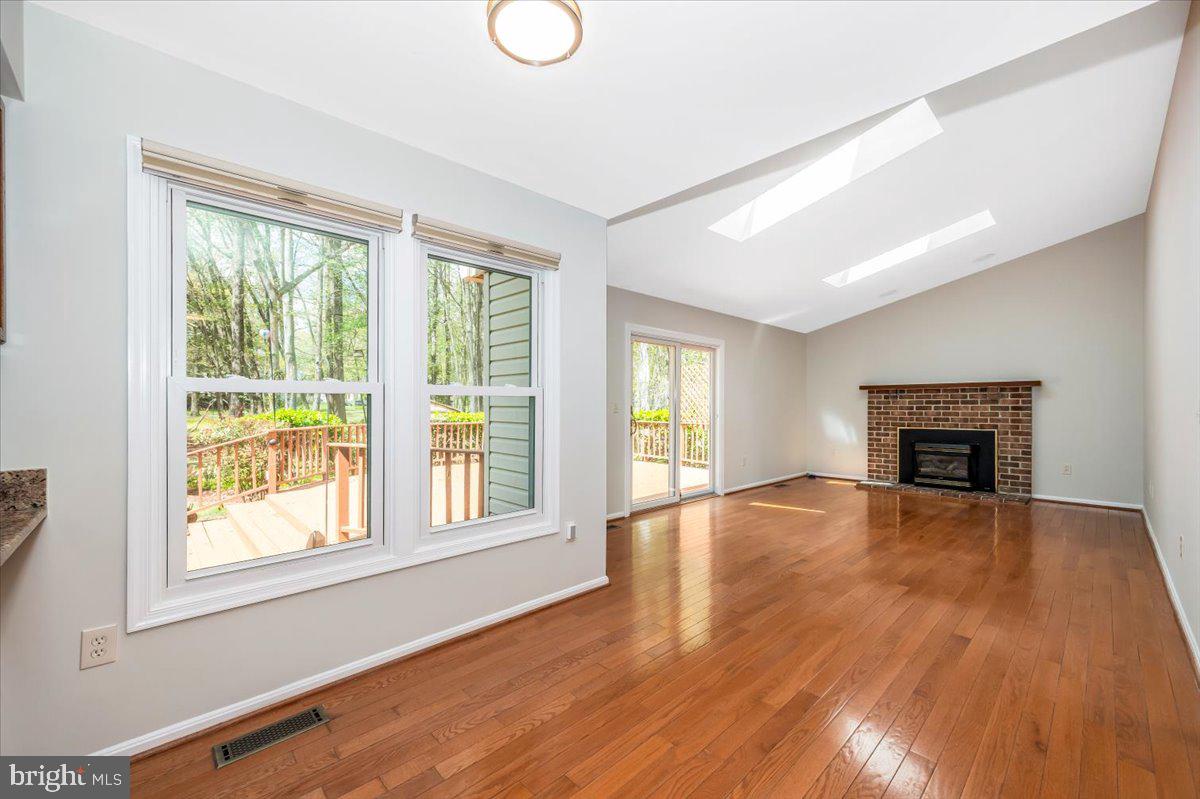 1402 Partridge Lane Bowie, MD 20721 - Photo 16 of 56 a view of empty room with wooden floor and fireplace