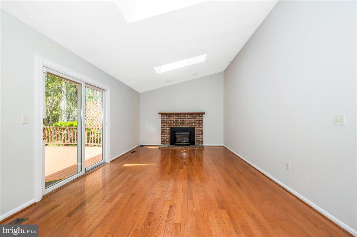 1402 Partridge Lane Bowie, MD 20721 - Photo 18 of 56 a view of an empty room with wooden floor and a window