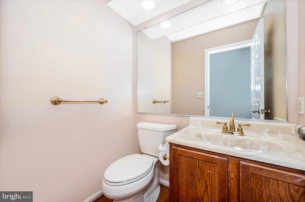 1402 Partridge Lane Bowie, MD 20721 - Photo 21 of 56 a bathroom with a granite countertop sink a toilet and a mirror