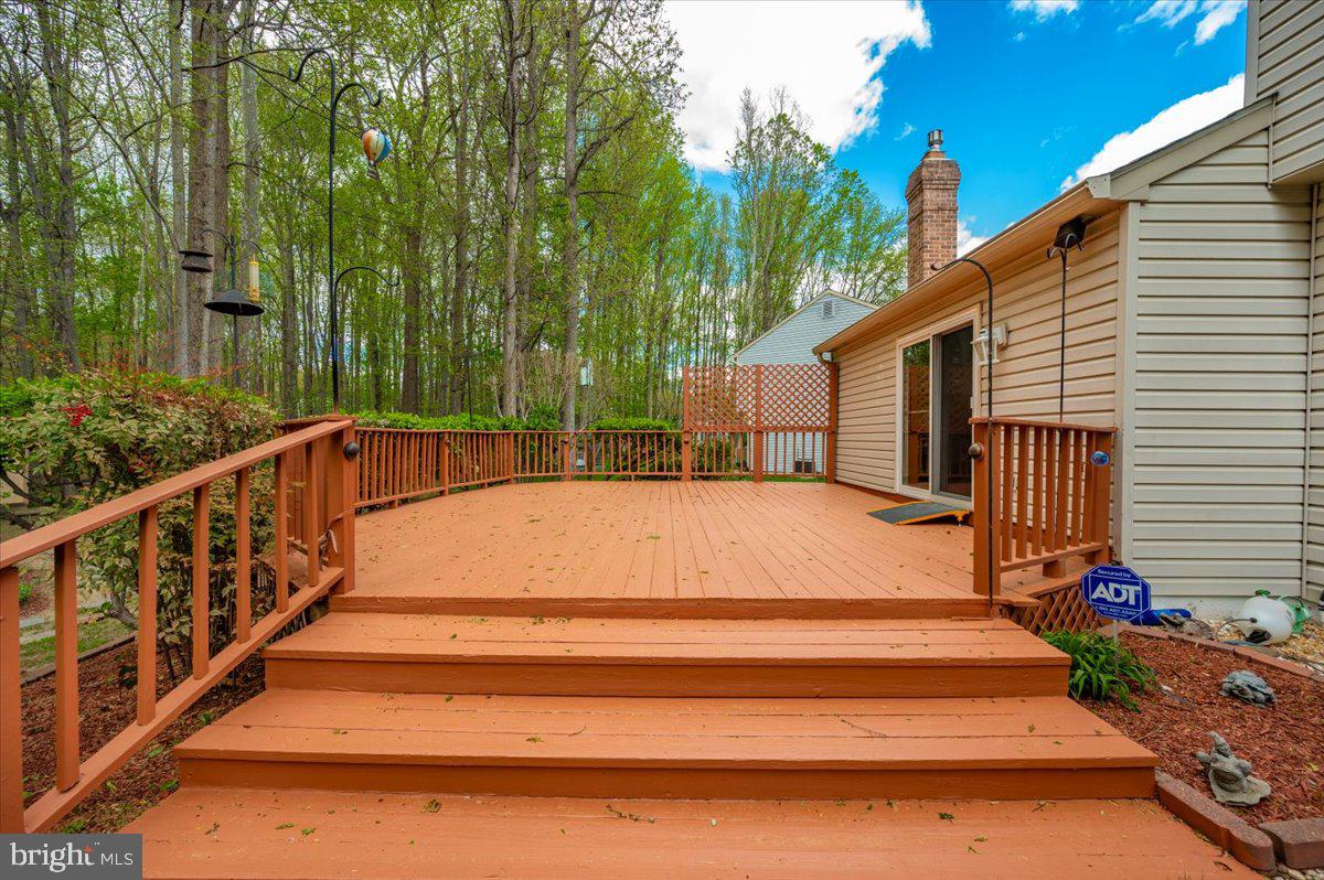 1402 Partridge Lane Bowie, MD 20721 - Photo 23 of 56 a view of backyard with wooden fence and large trees