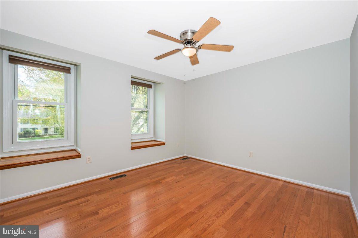 1402 Partridge Lane Bowie, MD 20721 - Photo 27 of 56 wooden floor in an empty room with a window