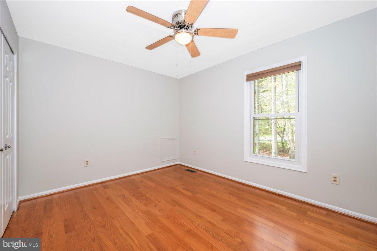 1402 Partridge Lane Bowie, MD 20721 - Photo 28 of 56 an empty room with a window and a ceiling fan