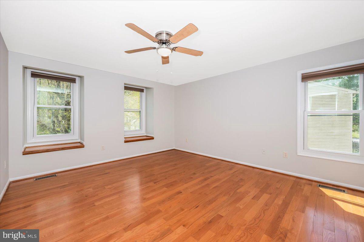 1402 Partridge Lane Bowie, MD 20721 - Photo 29 of 56 wooden floor in an empty room with a window