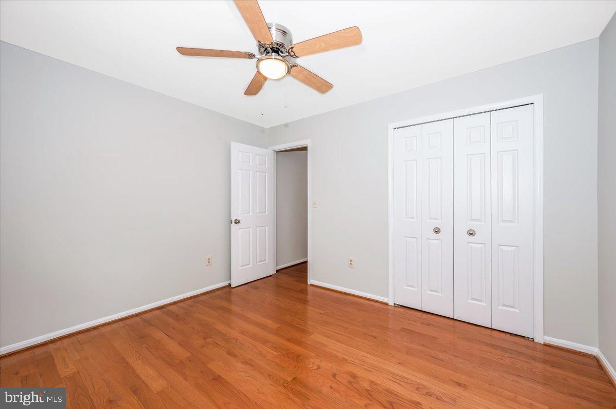 1402 Partridge Lane Bowie, MD 20721 - Photo 33 of 56 an empty room with wooden floor fan and windows
