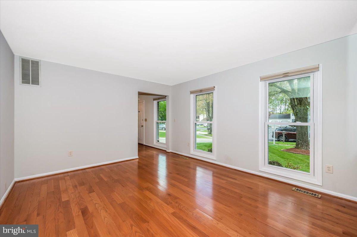 1402 Partridge Lane Bowie, MD 20721 - Photo 7 of 56 a view of an empty room with window and wooden floor