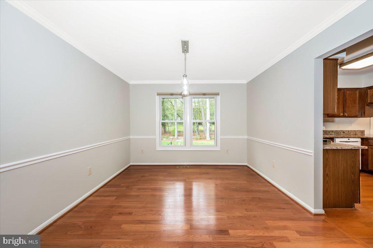 1402 Partridge Lane Bowie, MD 20721 - Photo 9 of 56 a view of empty room with wooden floor and fan