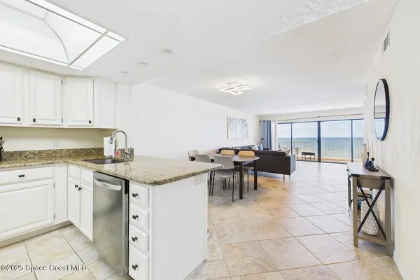 a kitchen with stainless steel appliances granite countertop a sink and cabinets
