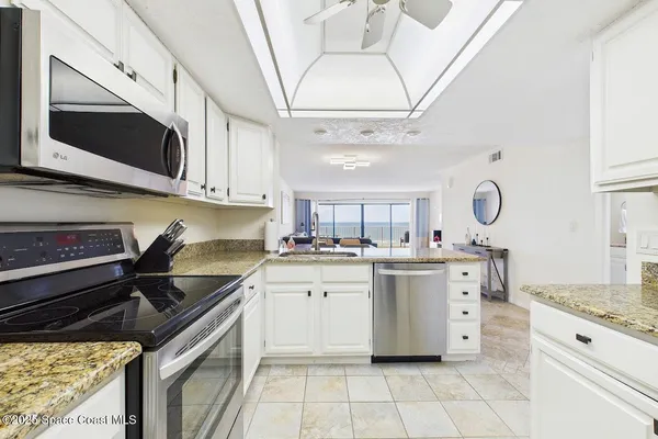 a kitchen with stainless steel appliances granite countertop a sink and a stove