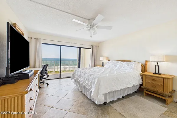 a bedroom with a bed and large flat screen tv