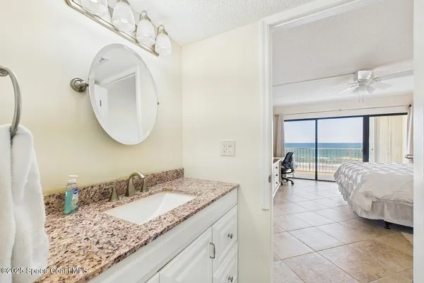 a bathroom with a granite countertop sink mirror and vanity