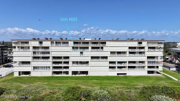 a view of a large building with a yard