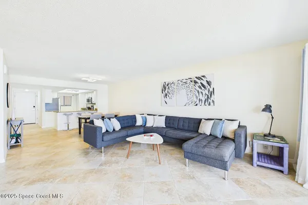 a living room with furniture and white walls