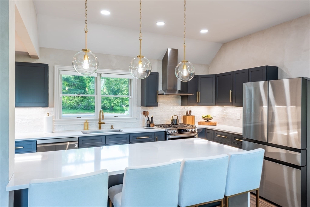 585 Station Road Amherst, MA 01002 - Photo 14 of 42 a kitchen with stainless steel appliances a sink a stove a refrigerator with a dining table and chairs