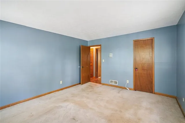 a view of an empty room with windows