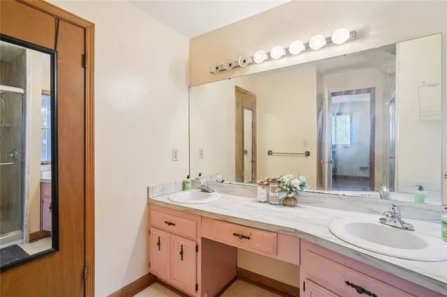 a bathroom with a shower and a glass door