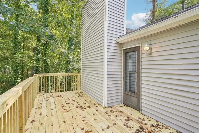 a view of a living room with a floor to ceiling window and wooden floor